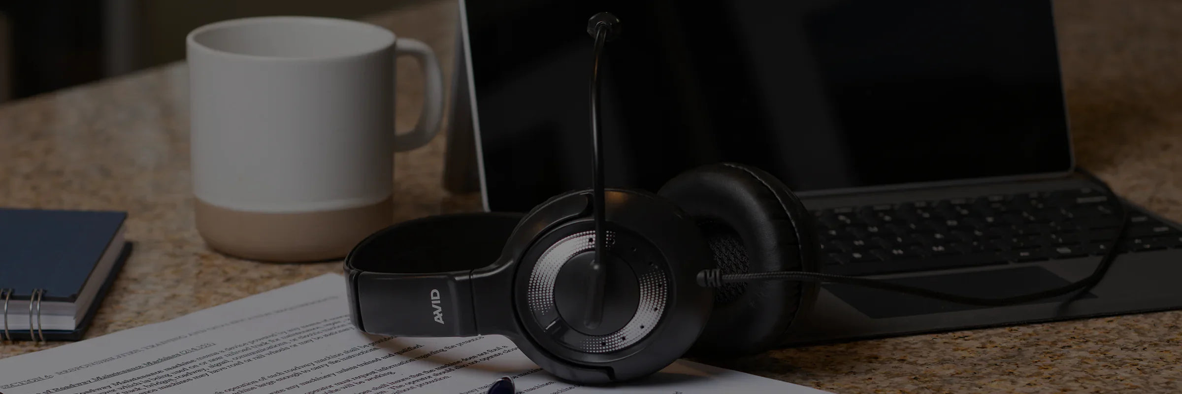 AVID AE-55 Wired Headset with Microphone on a Desk with laptop and coffee